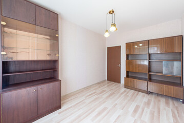 Empty Room with Wooden Cabinets and Bright Natural Light