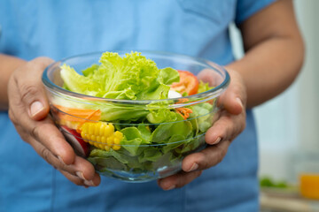Asian Nutritionist holding healthy food for patient in hospital, nutrition and vitamin.