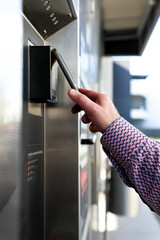 Mobile phone makes a contactless payment at a terminal, demonstrating modern digital technology,...
