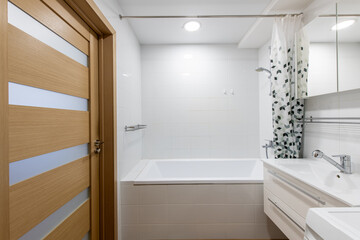 Modern Home White Bathroom Interior with Bathtub and Wooden Door