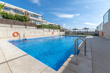 Pool complex in a luxury development with artificial waterfalls and multicolored
