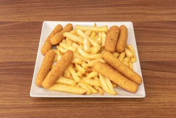Venezuelan-style breaded chicken fingers with a breadcrumb and ground corn mixture, fried golden brown and served with garlic sauce