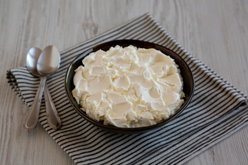Organic White Mascarpone Cheese in a Bowl, side view.