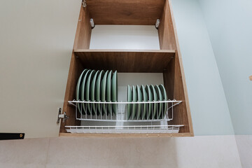 A beautifully designed Wooden Kitchen Cabinet elegantly displays Plates and enhances both modern cooking and dining spaces in your home, offering both aesthetic appeal and practical utility