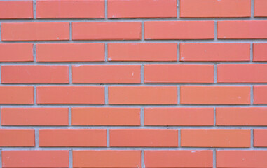 Close-up of a red brick wall with gray mortar joints