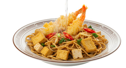 Plate of Asian stir-fried noodles with tofu cubes and crispy tempura shrimp, served on white patterned dish, perfect for seafood meals