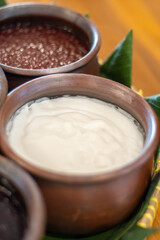 Bubur Sumsum, a traditional Indonesian dessert made from rice flour and coconut milk, served in an earthenware clay bowl. Authentic Southeast Asian porridge, soft and creamy texture, cultural heritage