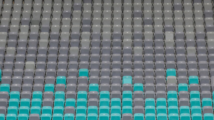 Fototapeta premium The stadium features a distinct pattern of grey and teal seats, showcasing an empty area before the match begins.