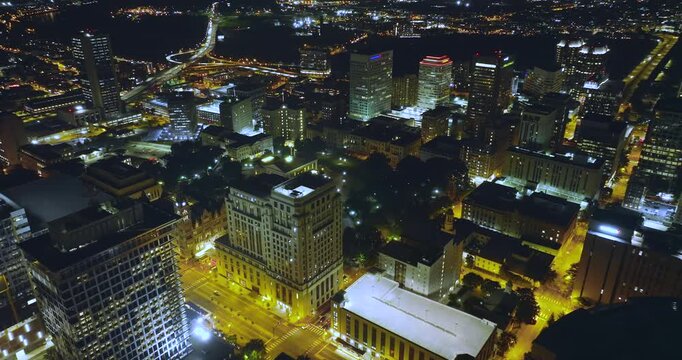 Aerial view of downtown district of Richmond city in Virginia, USA at night. Brightly illuminated high skyscraper buildings in modern American midtown.