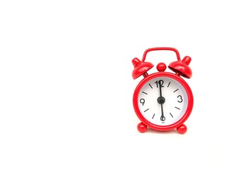 Naklejka premium Red alarm clock on white background. Time management and planning concept