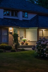 Entrance of luxury house with nice green Summer landscape at night in Vancouver, Canada, North America. August 2025