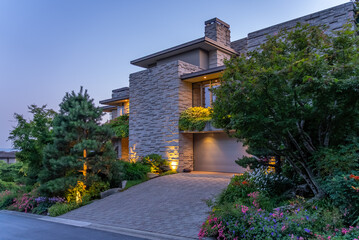Entrance of luxury house with nice green Summer landscape at night in Vancouver, Canada, North America. August 2025