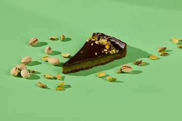 A Decadent Pistachio Chocolate Tart Slice is beautifully displayed on a Vibrant Background