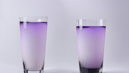 Two glasses with purple liquid gradient