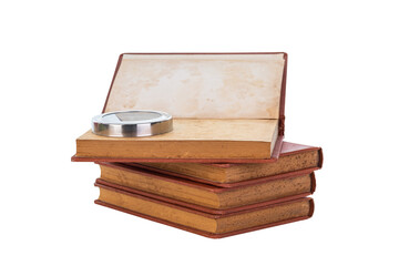 Old vintage book stack with a magnifying glass for research, search, and analysis concepts, isolated on white background with clipping path.