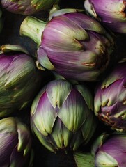 Obraz premium Fresh artichokes closeup. Macro flat lay of green and purple Italian artichokes with layered textured leaves.