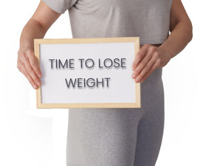 time to lose weight. words written on a whiteboard held by a woman dressed in sportswear