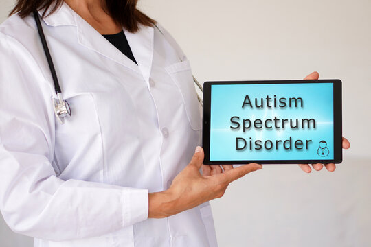 autism spectrum disorder. words written on a tablet held by a female doctor