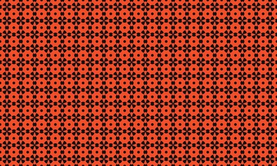 Pattern of black floral shapes and circles on an orange background creating a seamless design