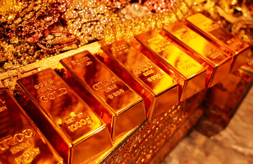 Stack of gold bars with the number 999.99 and Net WT 1000 g Gold bars and gold jewelry background. Financial concepts.