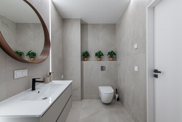 Modern Minimalist Bathroom With Stylish Fixtures and Wooden Mirror