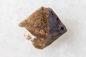 sample of unworked zircon crystal on white marble