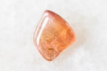 polished pink tourmaline crystal on white marble