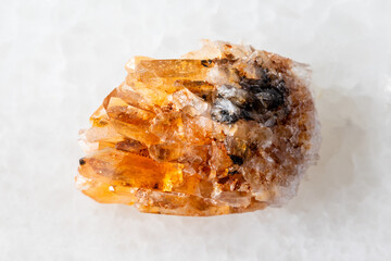 sample of rough creedite mineral on white marble