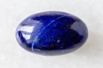 sample of polished lapis lazuli gemstone on white