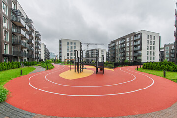 Modern Residential Playground with Athletic Track Surrounded by Urban Architecture © Mindaugas Dulinskas