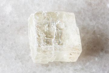 sample of raw iceland spar mineral on white marble