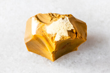 sample of raw yellow mookaite mineral on white