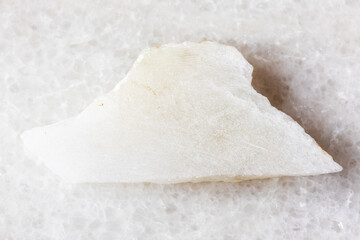 sample of polished white nephrite mineral on white