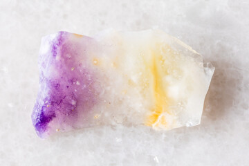 sample of rough opal mineral on white marble