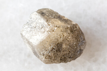 sample of raw phenakite stone on white marble