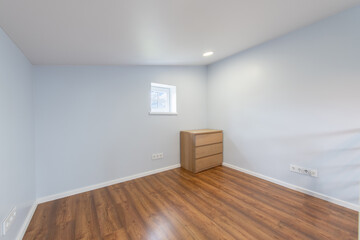 Minimalist Home Empty Room With Wood Flooring and Compact Wooden Dresser