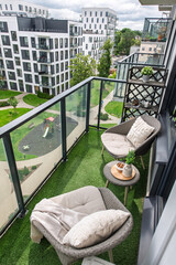 Obraz premium Modern Balcony with Stylish Patio Furniture Overlooking a Residential Area