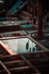 A stall selling objects at a village festival photographed up close with reflections and plays of light