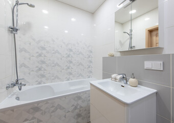 Modern Bathroom Interior with Bathtub, Sink, and Clean White Tiled Design