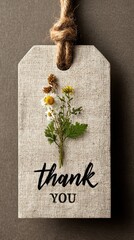 Natural thank you tag features flower arrangement on rustic background with twine