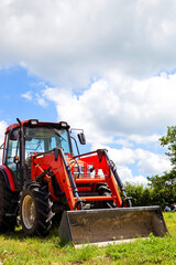 Agricultural Tractor in Farm Field Landscape During Daytime