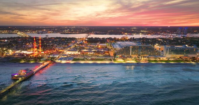 Daytona Beach, Florida. Tourist attractions and infrastructure at sunset. Illuminated luxurious hotels and apartment buildings in southern Florida, USA.