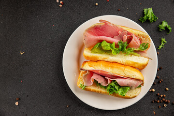 Ham sandwich green leaf salad, spam, meat snack vegetables natural product tasty tasty snack fresh delicious gourmet food background on the table rustic top view copy space