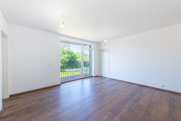Minimalist Apartment Interior with Wooden Floors and Large Balcony Windows