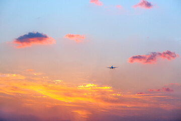 Airplane Descending Against Colorful Sunset Sky Aviation View