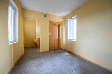 Quiet Residential Building Hallway with an Elevator and Spacious Windows