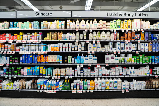View of suncare and body lotion products on pharmacy shelves. Toronto, Canada - September 20, 2025.