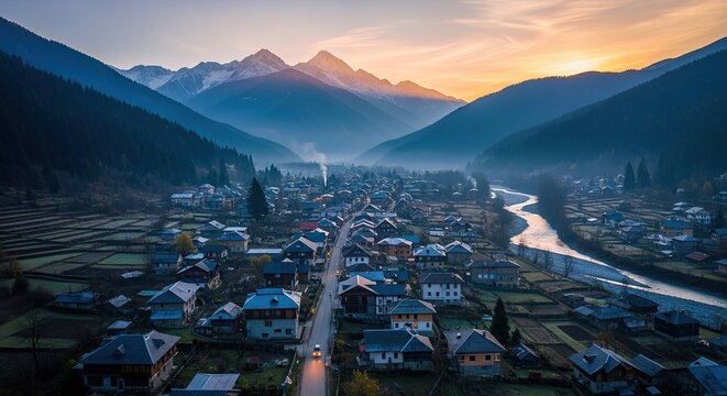 Aerial View of a Mountain Village at Sunrise, with River and Roa