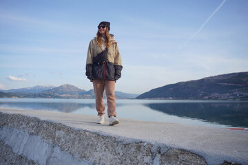 Young woman walking in front of the lake