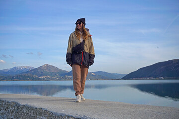 Young woman walking in front of the lake